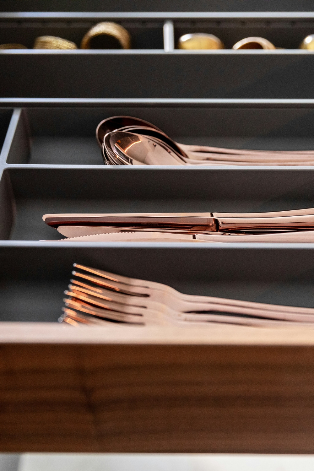 Kitchen drawer with adjustable dividers organizing utensils