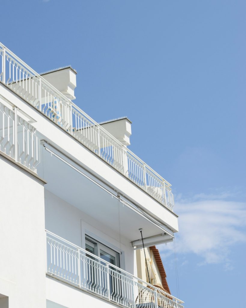 Warm LED string lights illuminating a cozy balcony at night