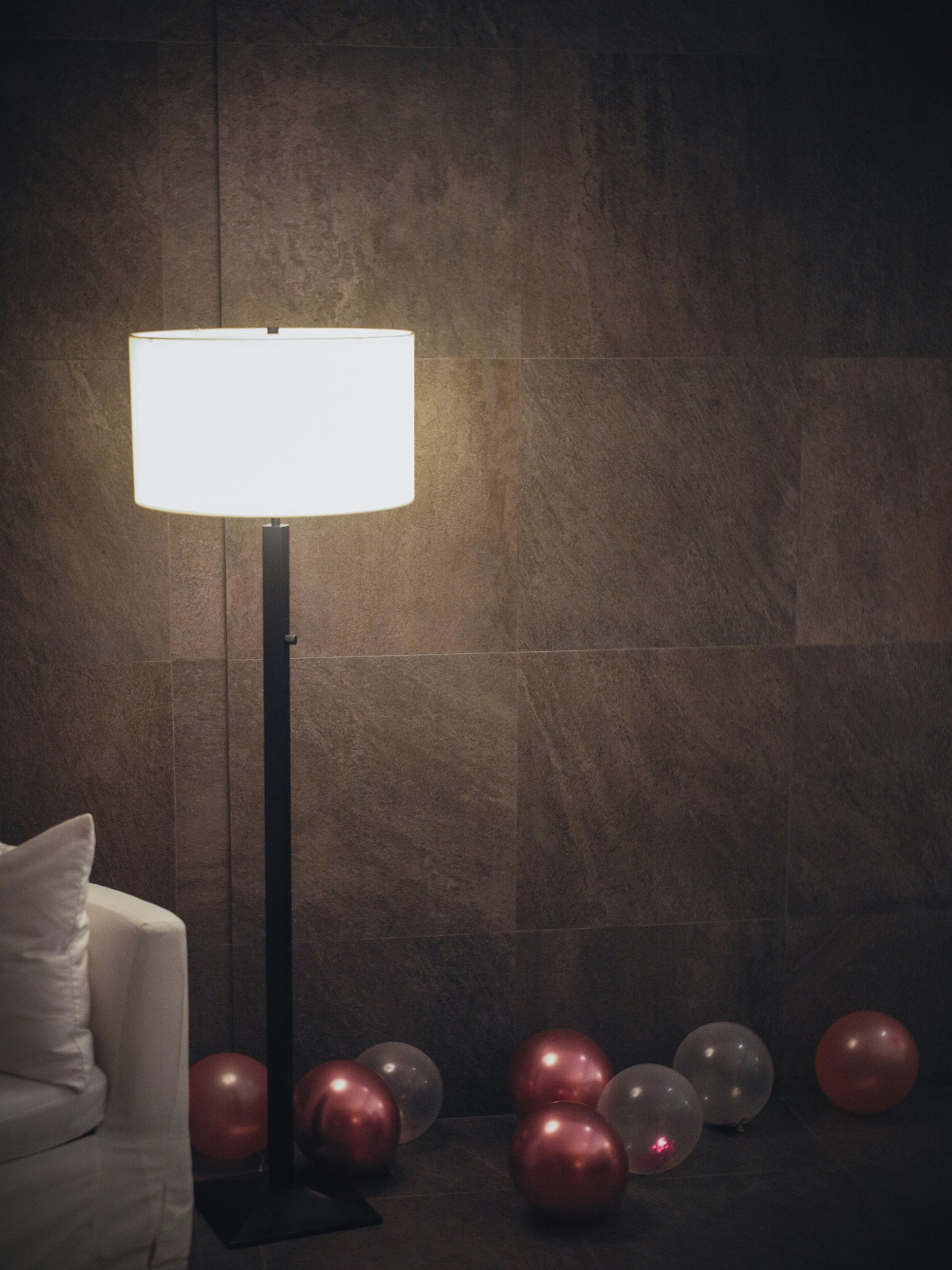 “Homeowner using smartphone app to control smart lighting in a luxury living room”