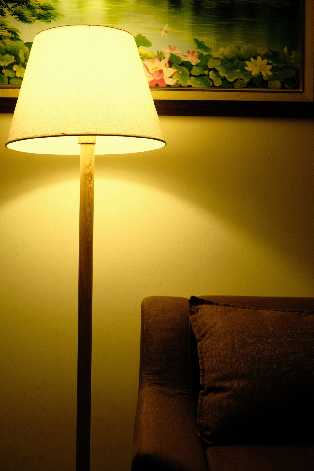 “Statement floor lamp illuminating empty living room corner with style”