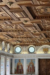 Small bedroom with light-colored wallpaper creating spacious feel