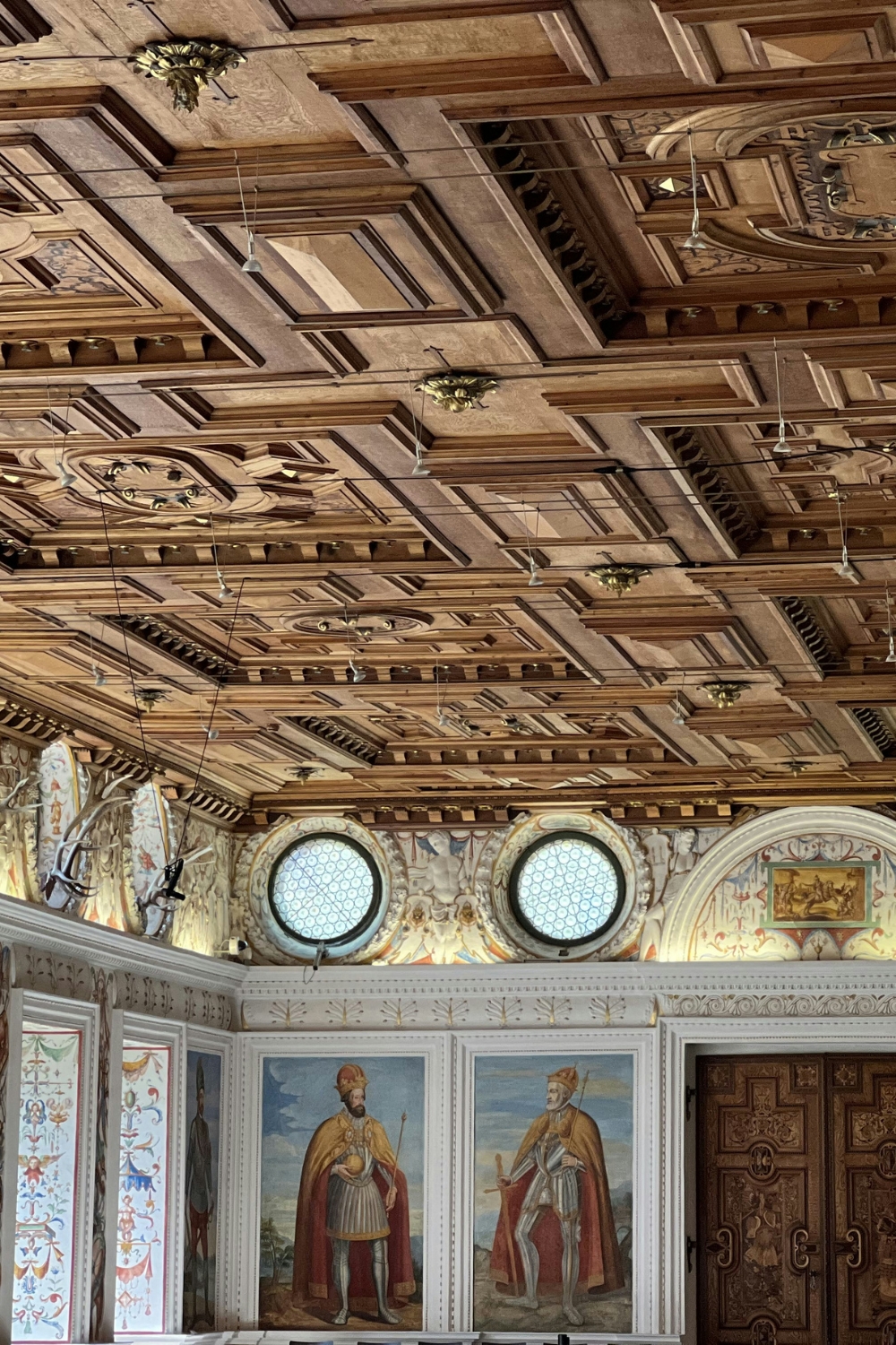 Small bedroom with light-colored wallpaper creating spacious feel