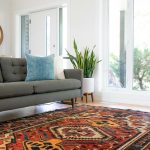 Modern living room with large wool area rug anchoring sofa and coffee table