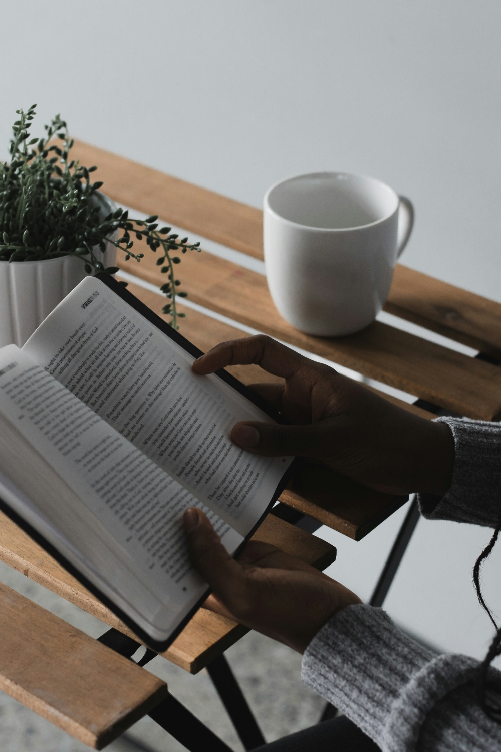 “Cozy reading nook with plush chair, throw blankets, and pillows”