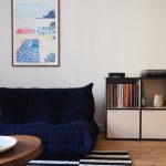 Modern minimalist living room with modular sofa and wooden coffee table