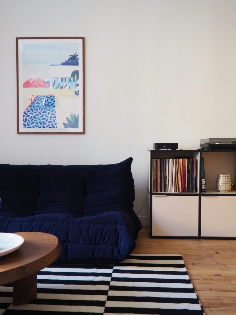 Modern minimalist living room with modular sofa and wooden coffee table