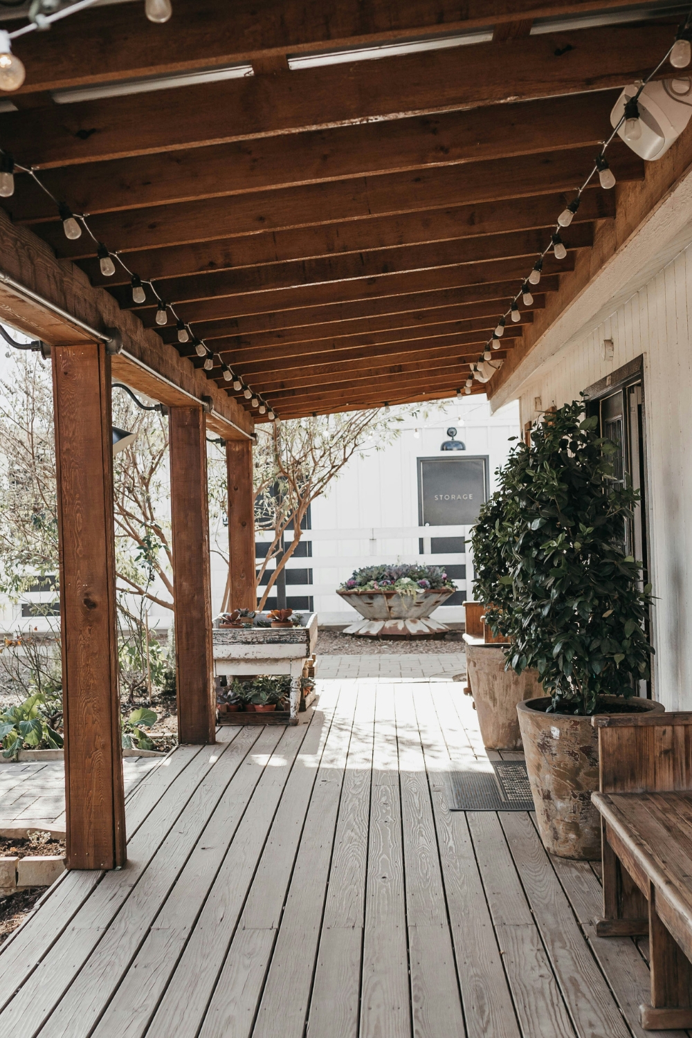 Cozy farmhouse living room with rustic wooden furniture and neutral rugs