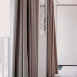 “modern living room with beige linen curtains matching neutral interiors”