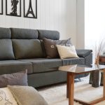 “Modern gray sectional sofa in a bright living room with LED lighting”