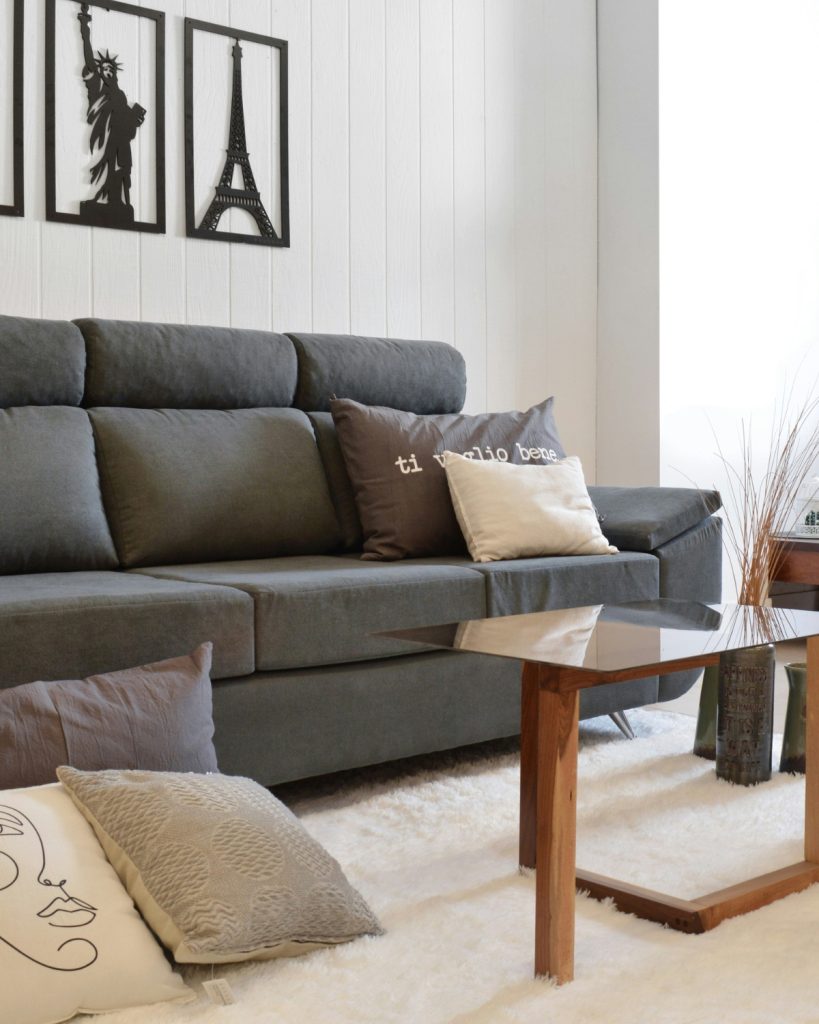 โModern gray sectional sofa in a bright living room with LED lightingโ