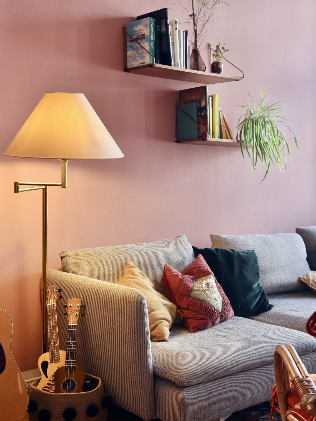 “Cozy reading nook in empty living room corner with armchair and floor lamp”