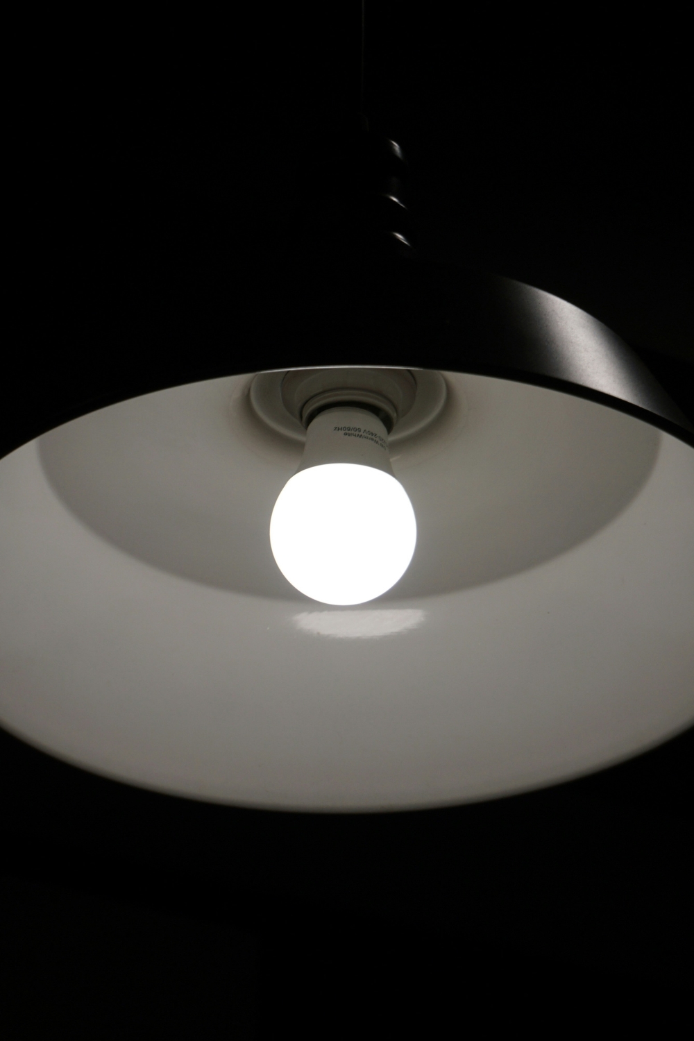 Small bedroom illuminated with layered LED and ambient lighting solutions.