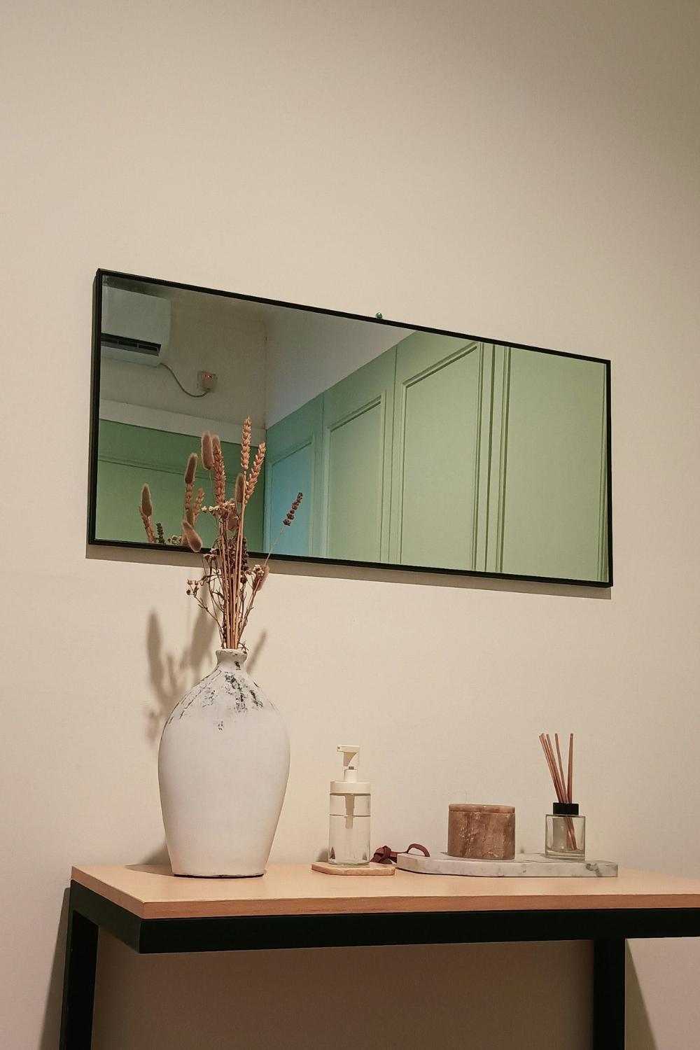 Learn how to use mirrors to brighten rooms and make spaces feel larger. Discover budget-friendly tips for placing mirrors to enhance your home décor.Large wall mirror reflecting natural light in a small living room