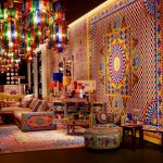 Living room decorated with cultural and heritage inspired décor featuring traditional artwork and handcrafted textiles