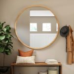 Large wall mirror reflecting natural light in a living room