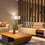 Luxury living room decorated on a budget with neutral tones, layered textures, and modern high-end accents