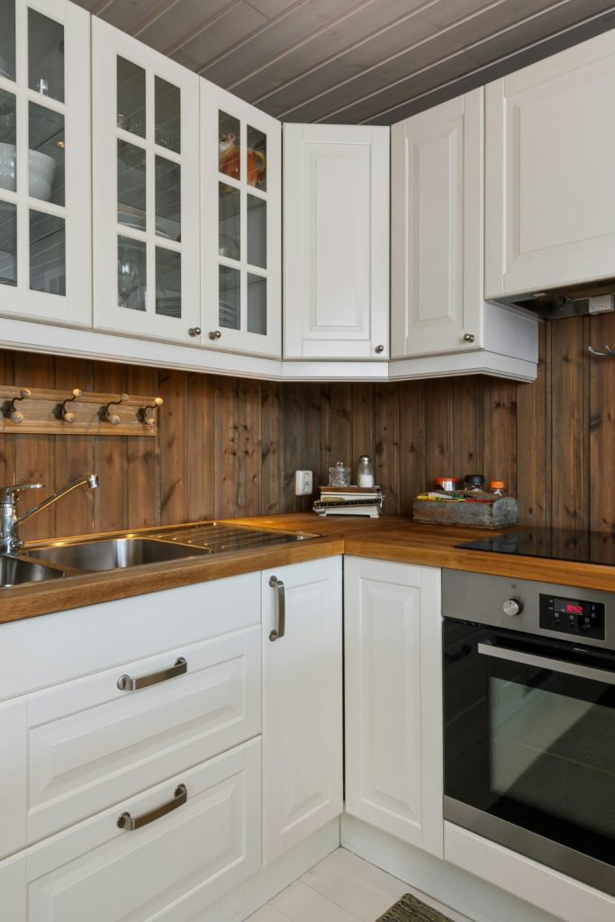 Rustic farmhouse kitchen with reclaimed wood shelves and vintage lighting