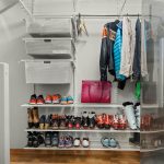 Organized small closet with shelves and hanging rods for maximum space
