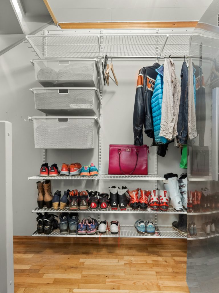 Organized small closet with shelves and hanging rods for maximum space