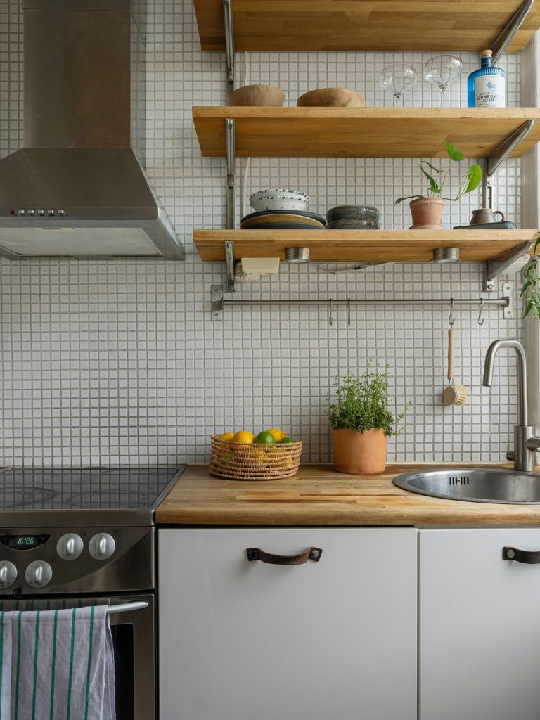 Minimalist white kitchen with clean countertops and modern lighting