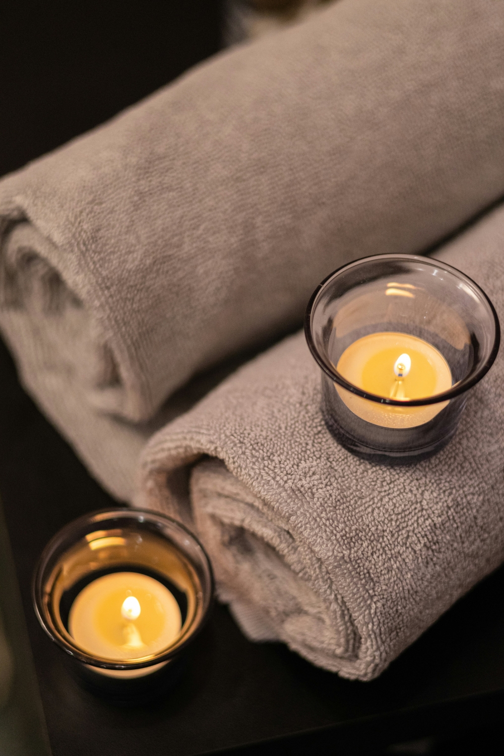 Spa bathroom with scented candles and essential oils creating a relaxing atmosphere