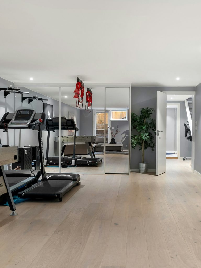 Budget-friendly home gym setup with resistance bands, dumbbells, and a foldable exercise mat