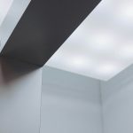 Gallery ledge with LED spotlights highlighting framed artwork