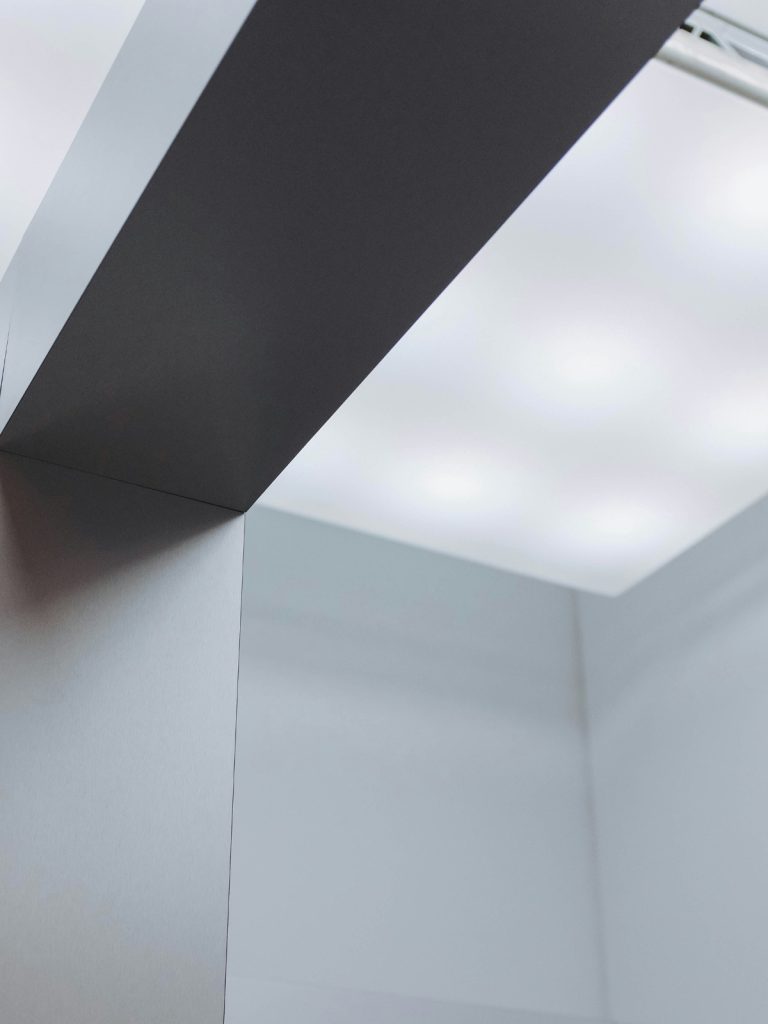 Gallery ledge with LED spotlights highlighting framed artwork