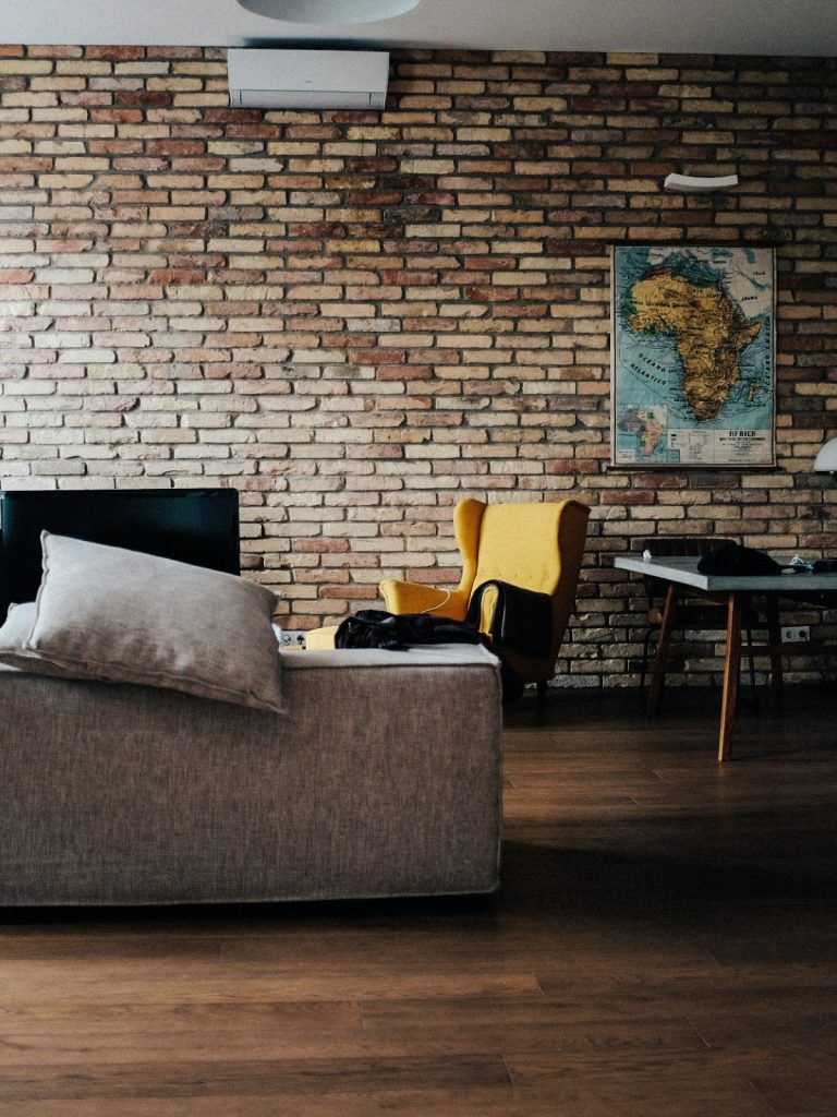 Living room showing common home decor mistakes like poor lighting and small rug