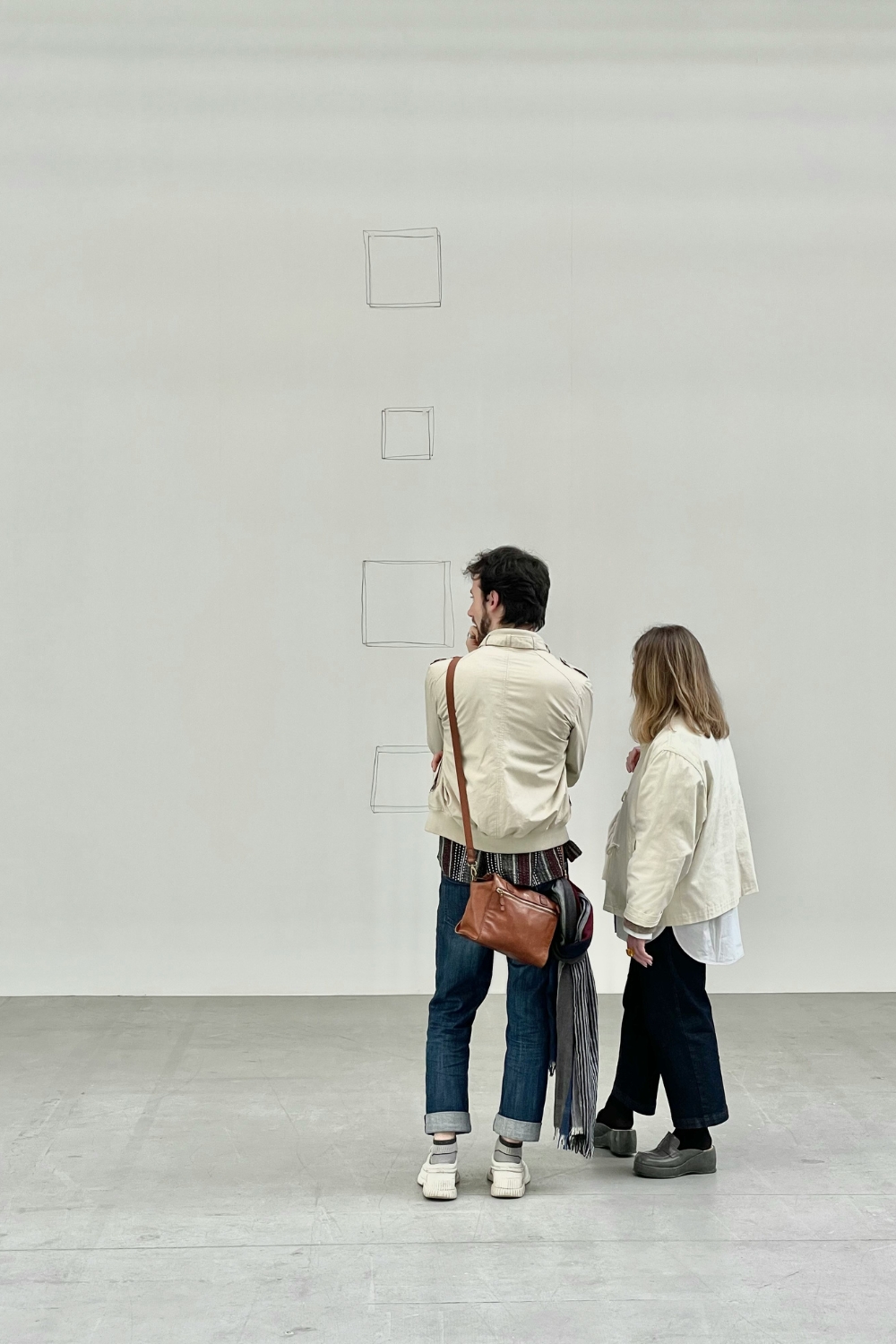 Clean and modern gallery wall with perfectly spaced frames in a living room