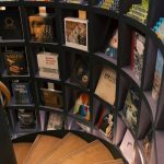 Modern bookshelf with colorful books arranged by size in a stylish home library