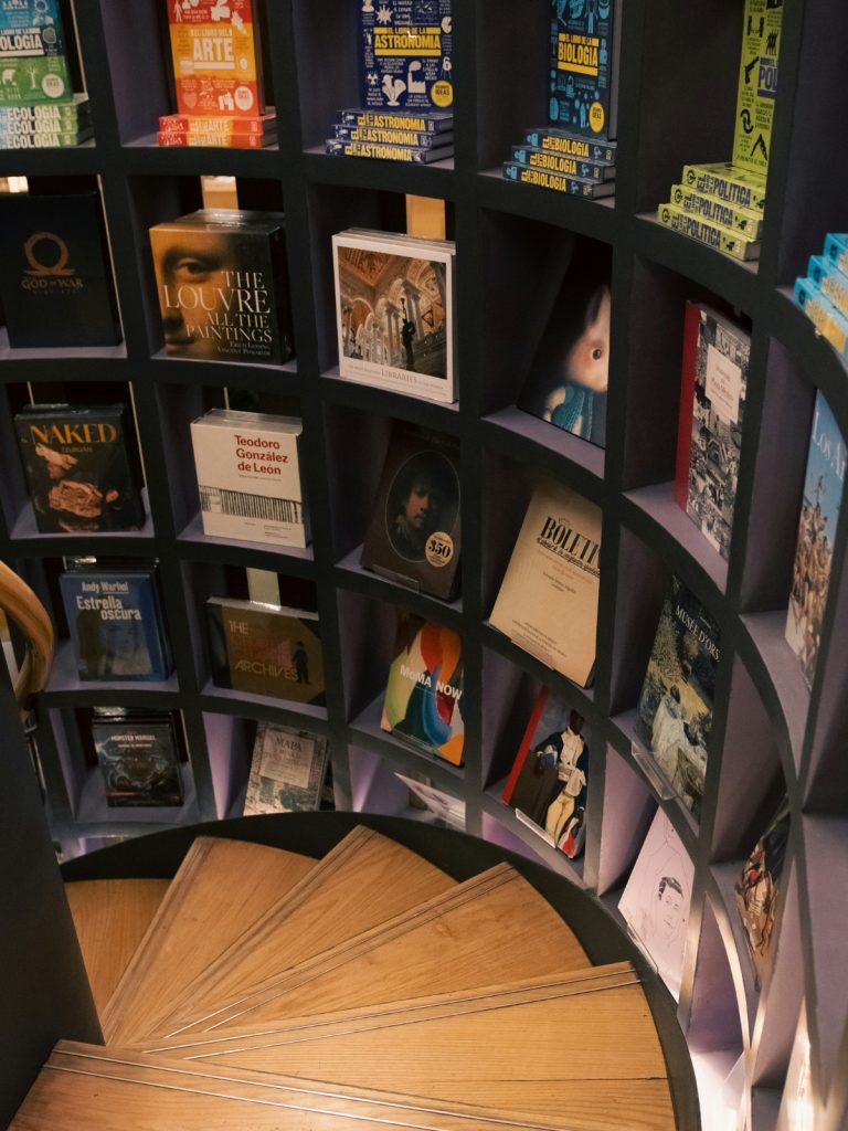 Modern bookshelf with colorful books arranged by size in a stylish home library