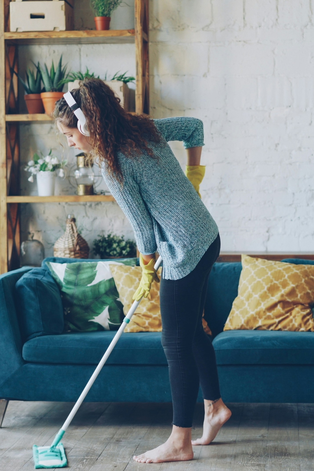 Person wiping down a kitchen counter as part of daily cleaning routine