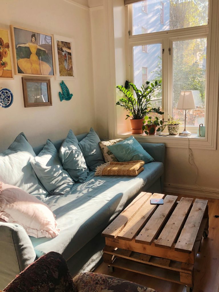 Living room setup after moving into a new home with cozy lighting and simple furniture layout