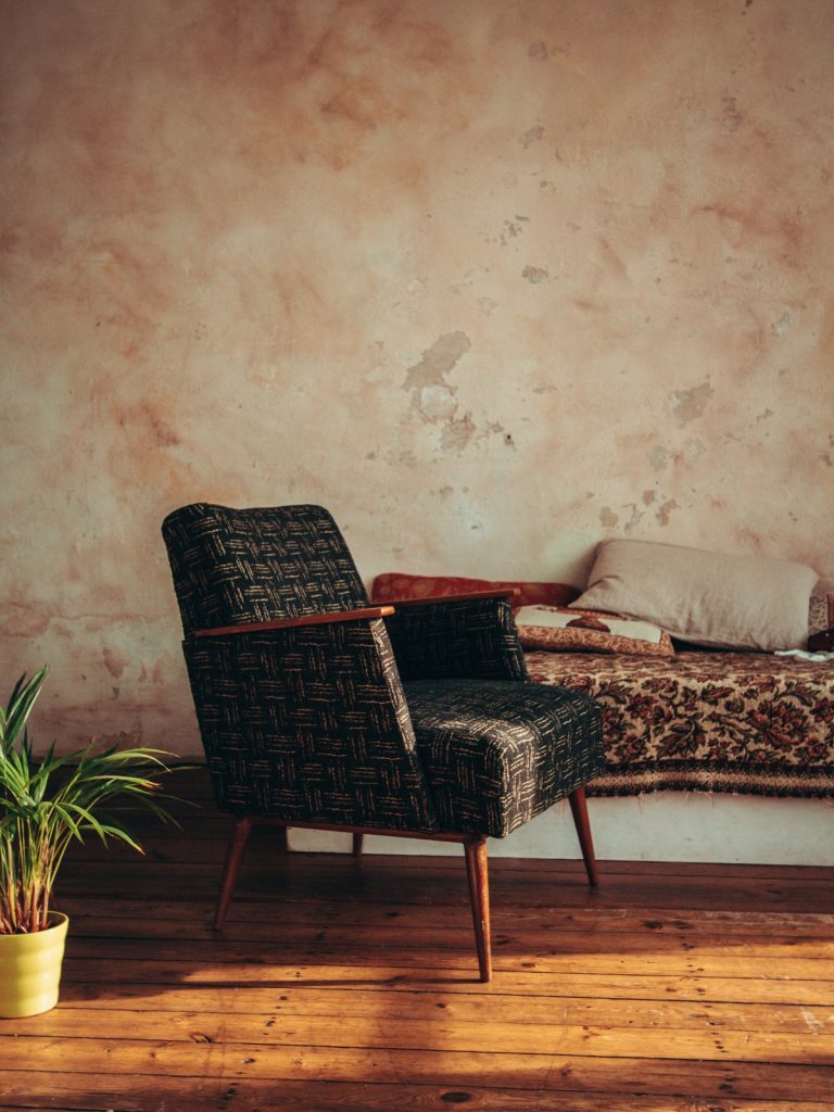 Rustic wooden furniture paired with modern minimalist sofa in a bright, timeless living room interior