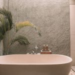 Minimalist spa-inspired bathroom with neutral tones and soft lighting