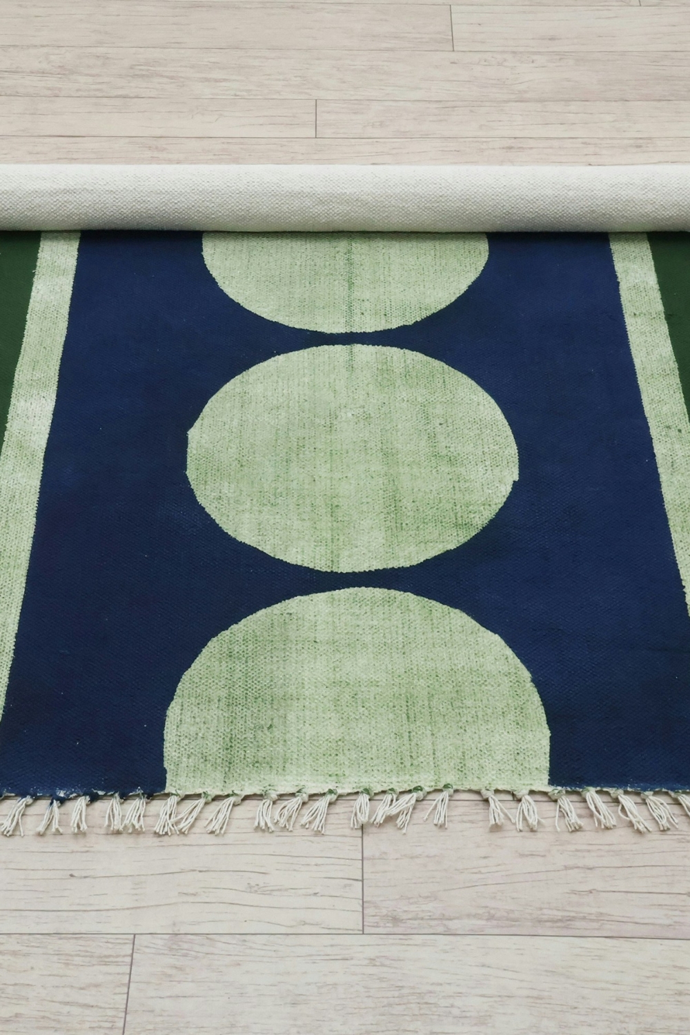 Layered rugs defining flexible seating area in open-plan home