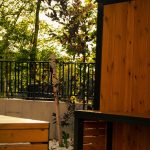 Compact bistro table and chairs arranged for outdoor dining on a small balcony