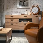 Mixed-material furniture featuring wood, metal, and glass styled in a modern living room