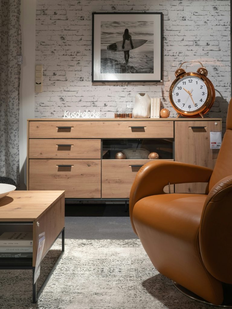 Mixed-material furniture featuring wood, metal, and glass styled in a modern living room