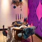 Modern gallery wall with mixed frames and contemporary artwork in a living room.