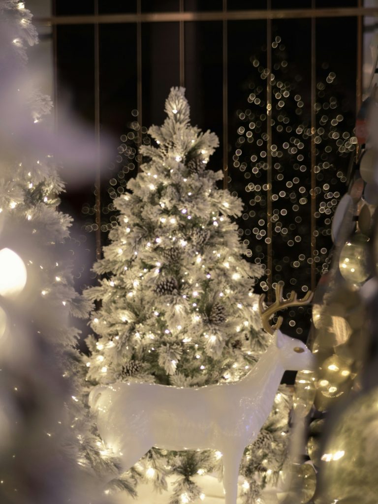 Twinkling fairy lights draped across evergreen garlands on a festive mantel