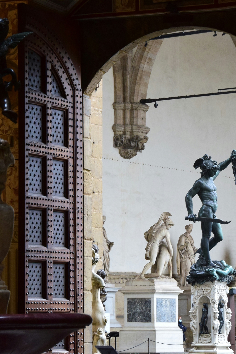 Modern white pedestal displaying a contemporary sculpture in a stylish living room
