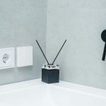 Small bathroom organized with smart storage accessories like wall shelves, baskets, and pull-out drawers