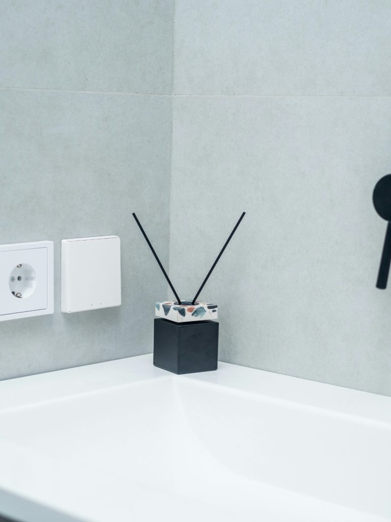 Small bathroom organized with smart storage accessories like wall shelves, baskets, and pull-out drawers