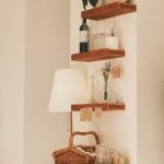 Living room shelf styled using the Rule of Thirds with books, plants, and decorative objects