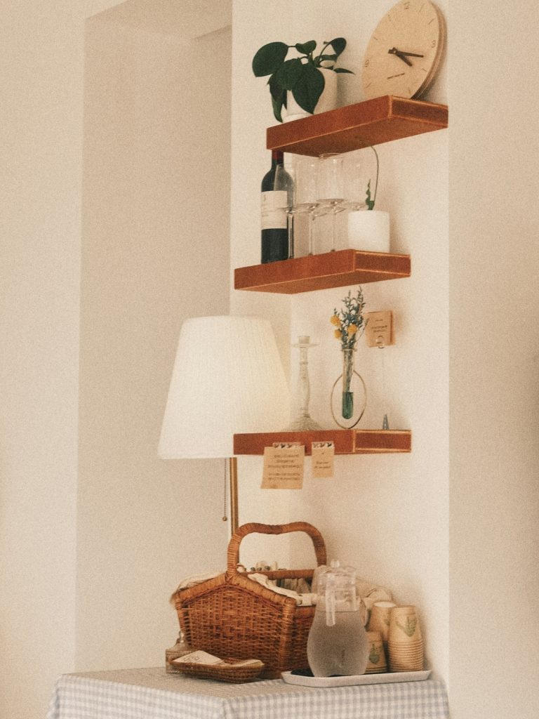 Living room shelf styled using the Rule of Thirds with books, plants, and decorative objects
