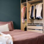 Smartly organized shared bedroom with space-saving storage, bunk beds, shelves, and designated areas for each child.