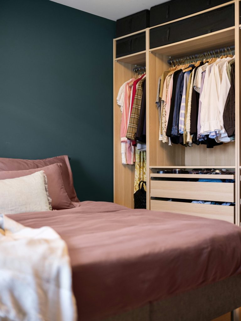 Smartly organized shared bedroom with space-saving storage, bunk beds, shelves, and designated areas for each child.