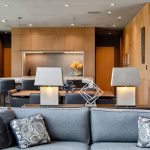 Bedroom styled like a luxury hotel with crisp white bedding, plush pillows, and warm ambient lighting